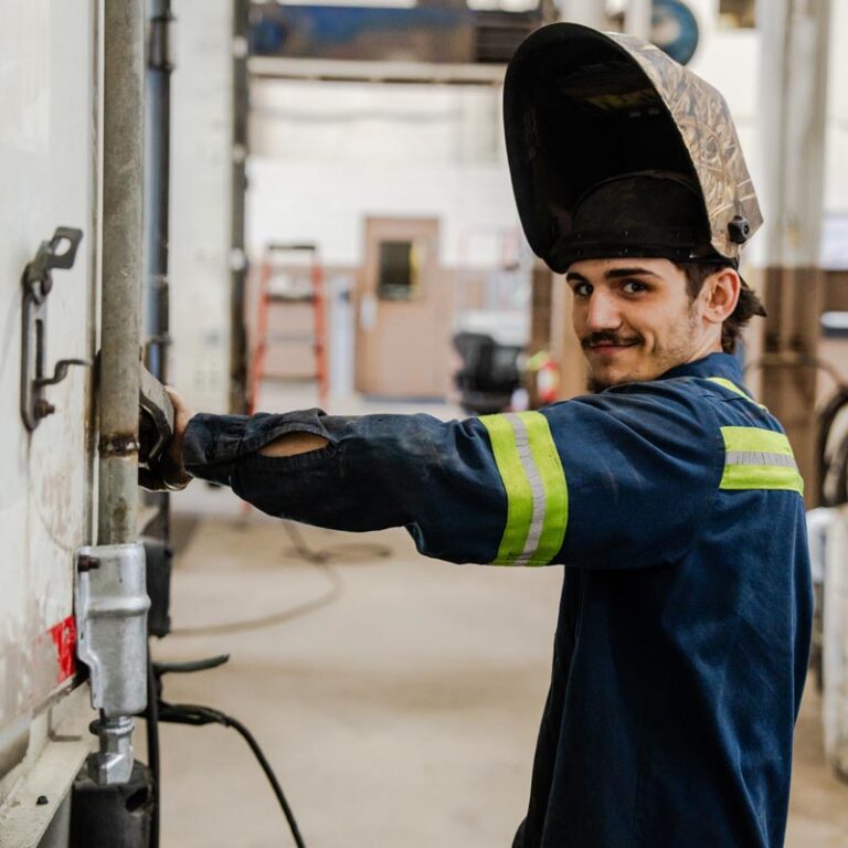 Trucking employee working on a truck